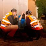 Volunteers helping patient