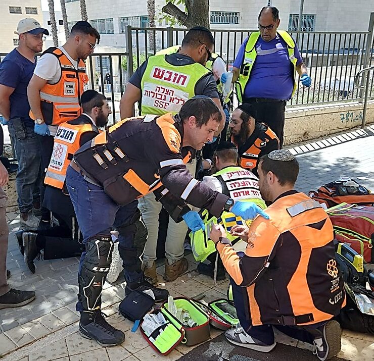 United Hatzalah volunteers treat a patient who collapsed in a Jerusalem park