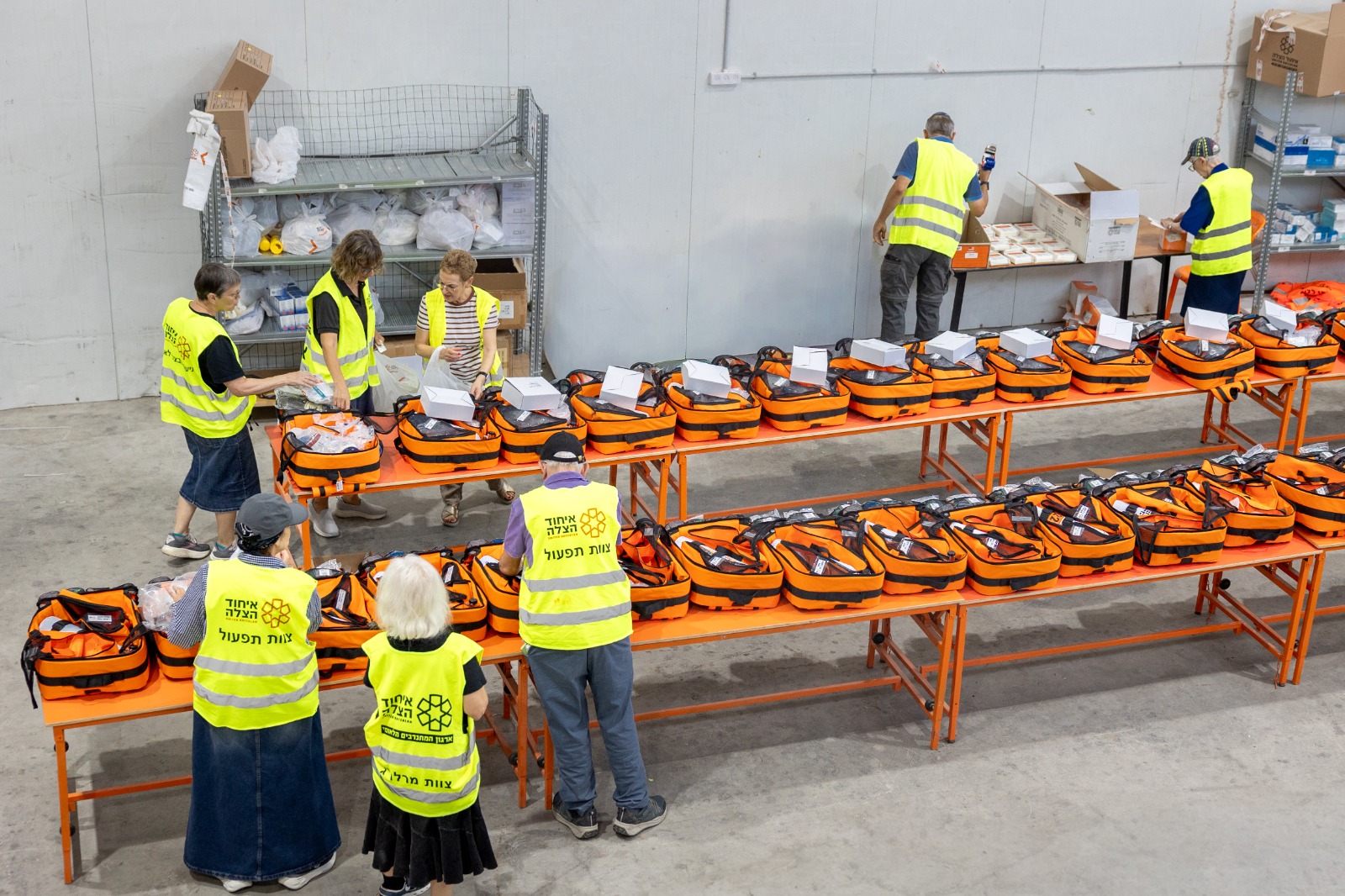 Volunteers packing medic bags in United Hatzalah's Logistic Center